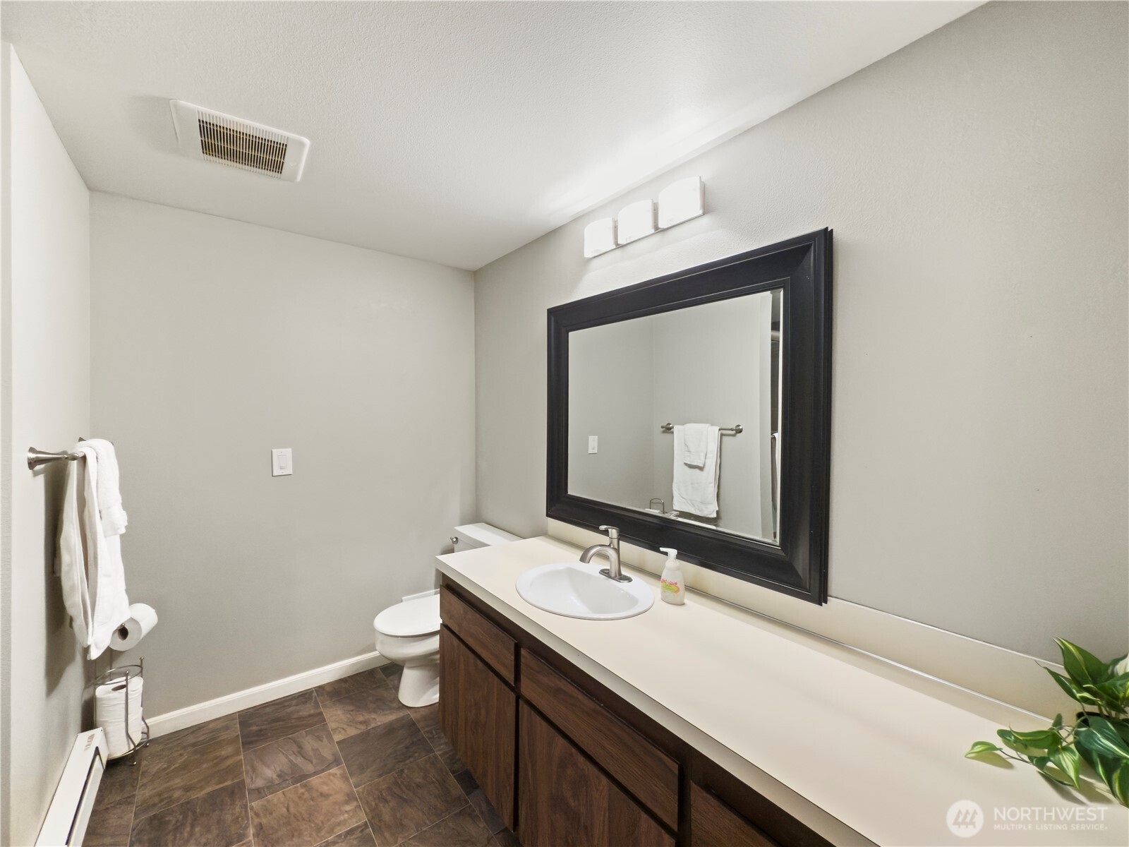 444 South State Street, Unit 307 Bellingham, WA 98225 - Photo 16 of 34 a bathroom with a toilet a sink and mirror