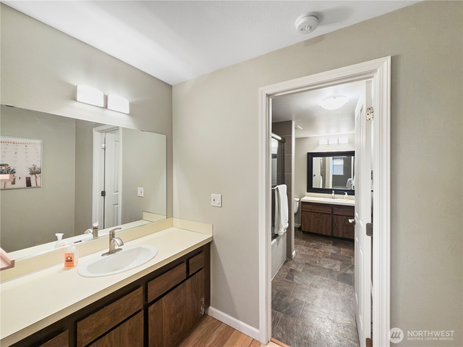 444 South State Street, Unit 307 Bellingham, WA 98225 - Photo 17 of 34 a en suite bathroom with a sink a mirror and a