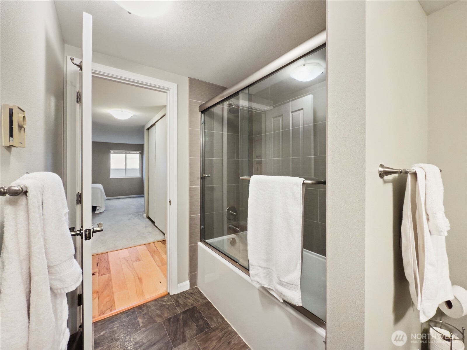 444 South State Street, Unit 307 Bellingham, WA 98225 - Photo 18 of 34 a bathroom with a tub sink and mirror