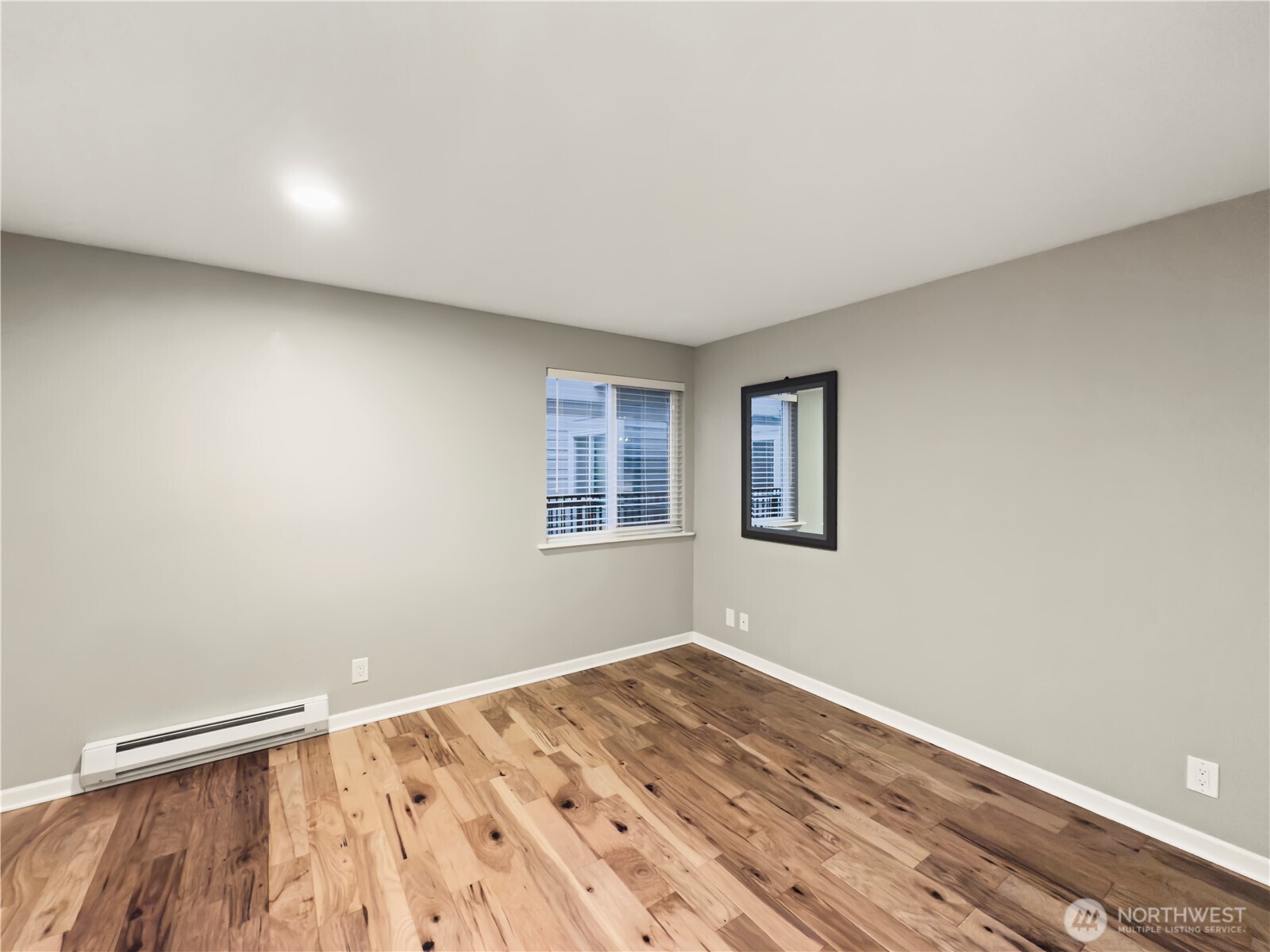 444 South State Street, Unit 307 Bellingham, WA 98225 - Photo 21 of 34 a view of an empty room with wooden floor and a window