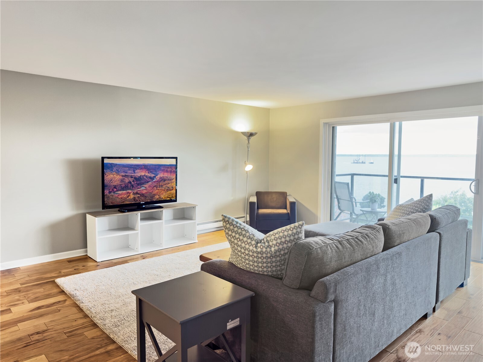 444 South State Street, Unit 307 Bellingham, WA 98225 - Photo 5 of 34 a living room with furniture floor to ceiling window and a flat screen tv