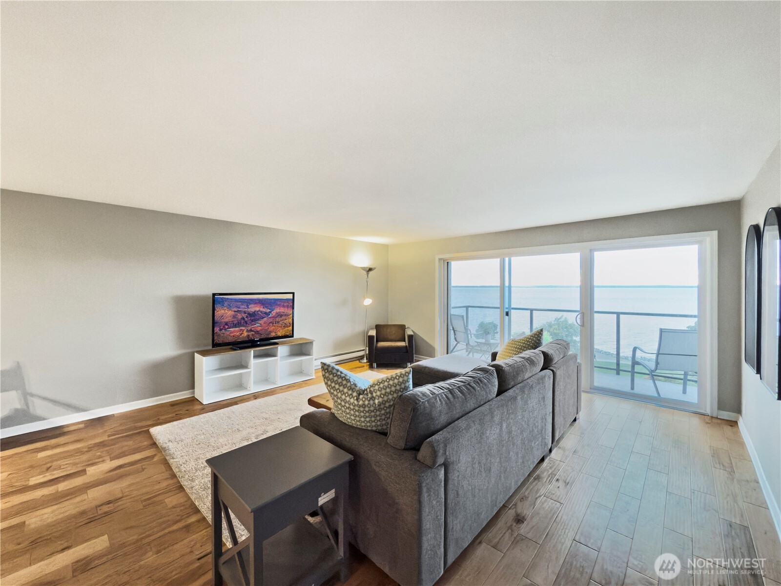 444 South State Street, Unit 307 Bellingham, WA 98225 - Photo 9 of 34 a living room with furniture and a floor to ceiling window