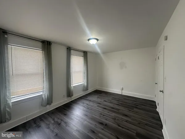 a view of wooden floor and windows in a room