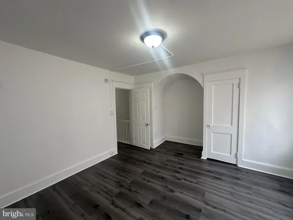 a view of a room with wooden floor and white walls
