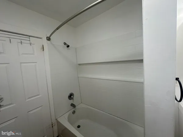 a bathroom with a tub and shower