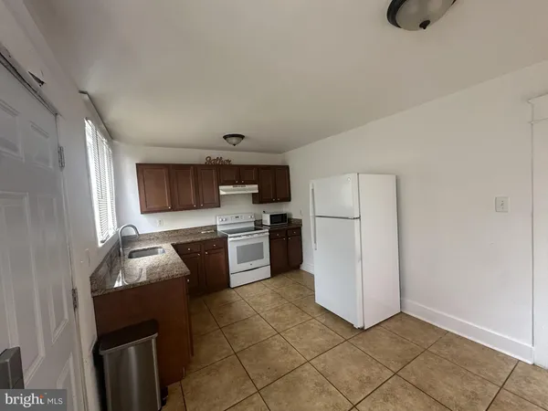 a kitchen with a refrigerator sink and stove