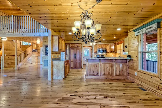 a kitchen with granite countertop sink and cabinets