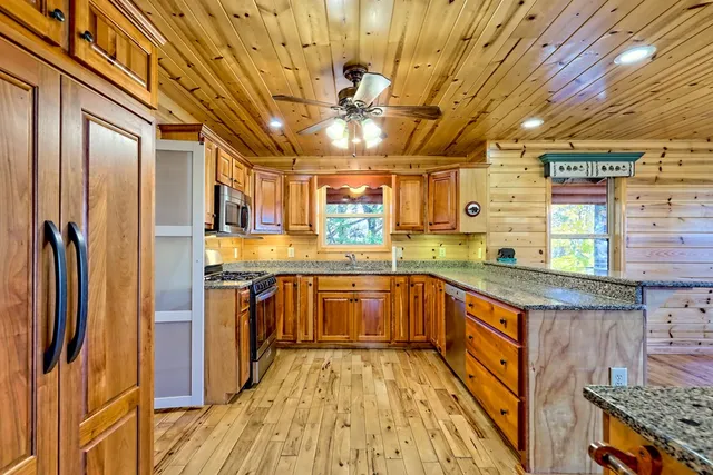 a view of empty room with wooden floor and fireplace