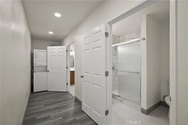 a view of a hallway with closet and wooden floor