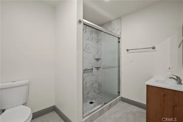 a bathroom with a shower a toilet and sink