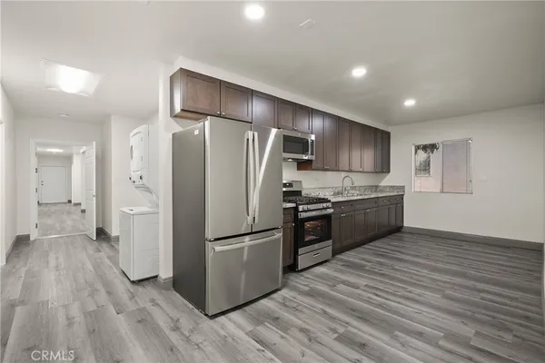 a kitchen with a refrigerator a sink and dishwasher