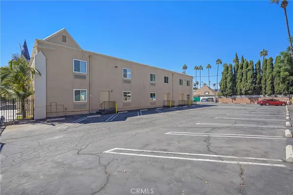 a large white house with a large parking space