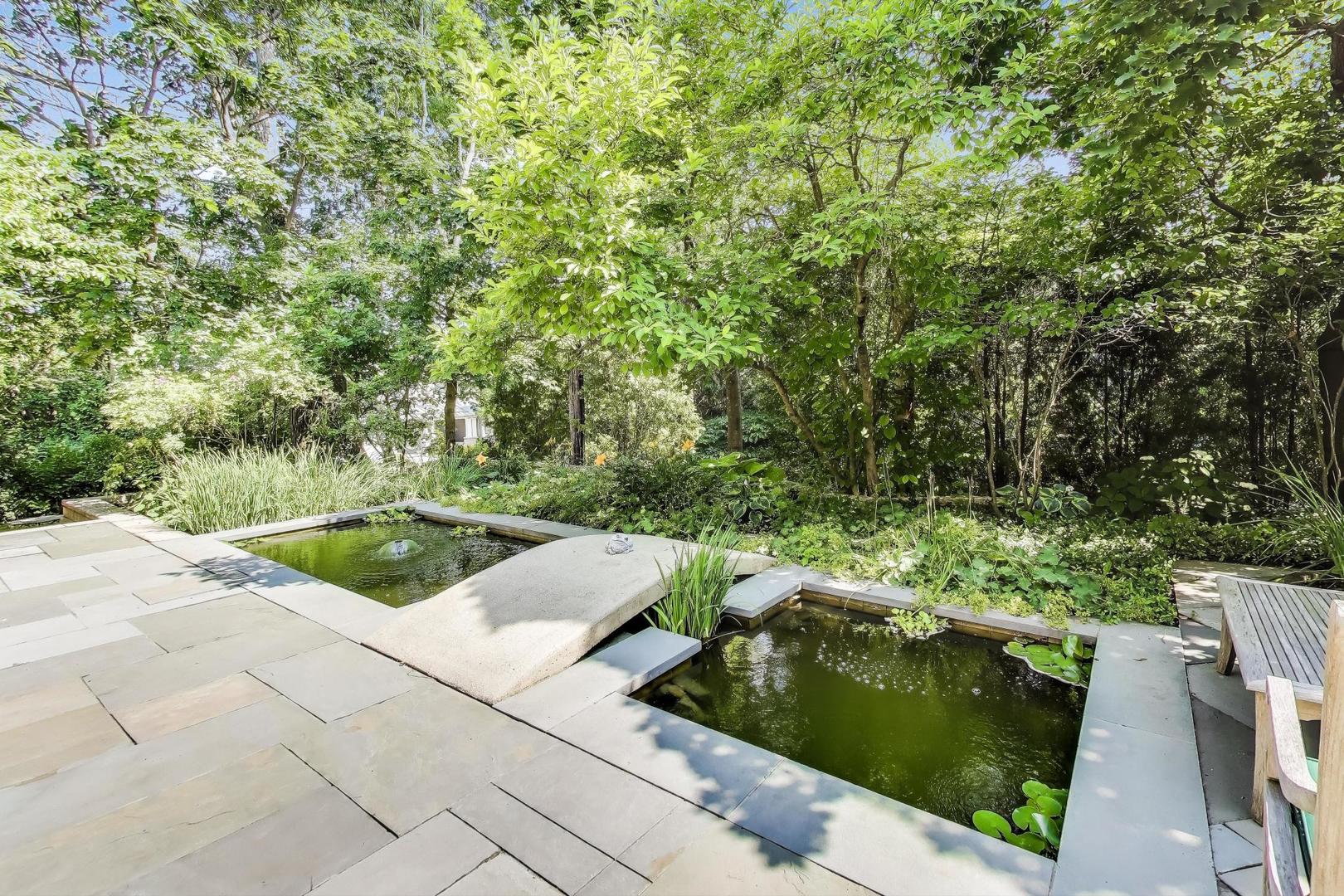 90 Riparian Road Highland Park, IL 60035 - Photo 60 of 76 a view of a garden with a fountain