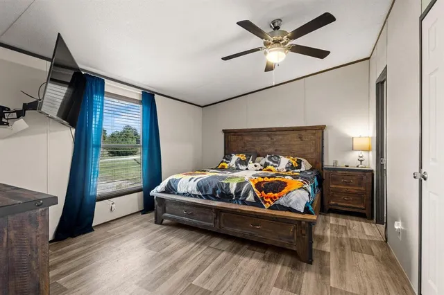 a bedroom with furniture and a large window