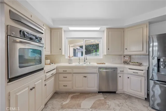 a kitchen with a sink stove and cabinets