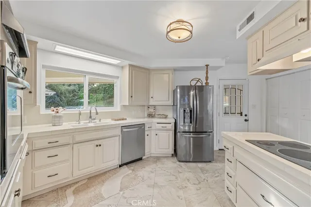 a kitchen with a refrigerator and a sink