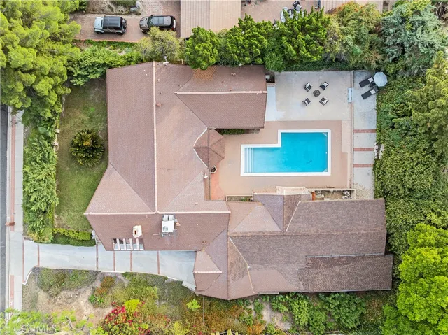 an aerial view of a house with garden space and street view