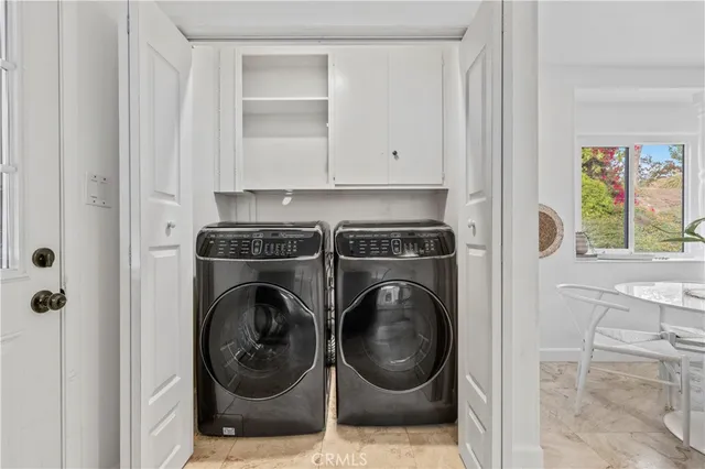 a view of a kitchen with washer and dryer