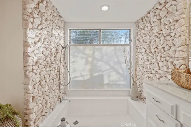 a bathroom with a bathtub and shower