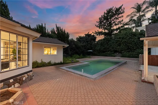 a view of a backyard with swimming pool