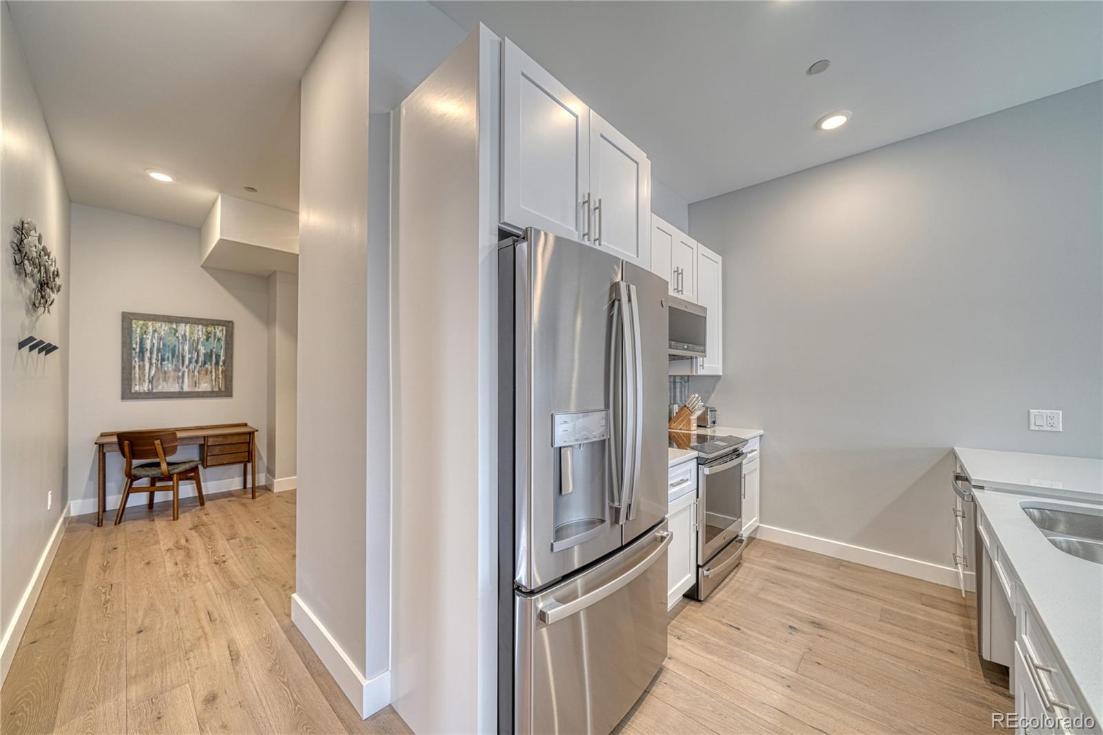 136 Old Stage Road, Unit 1B Salida, CO 81201 - Photo 11 of 24 a kitchen with stainless steel appliances granite countertop a refrigerator and a sink