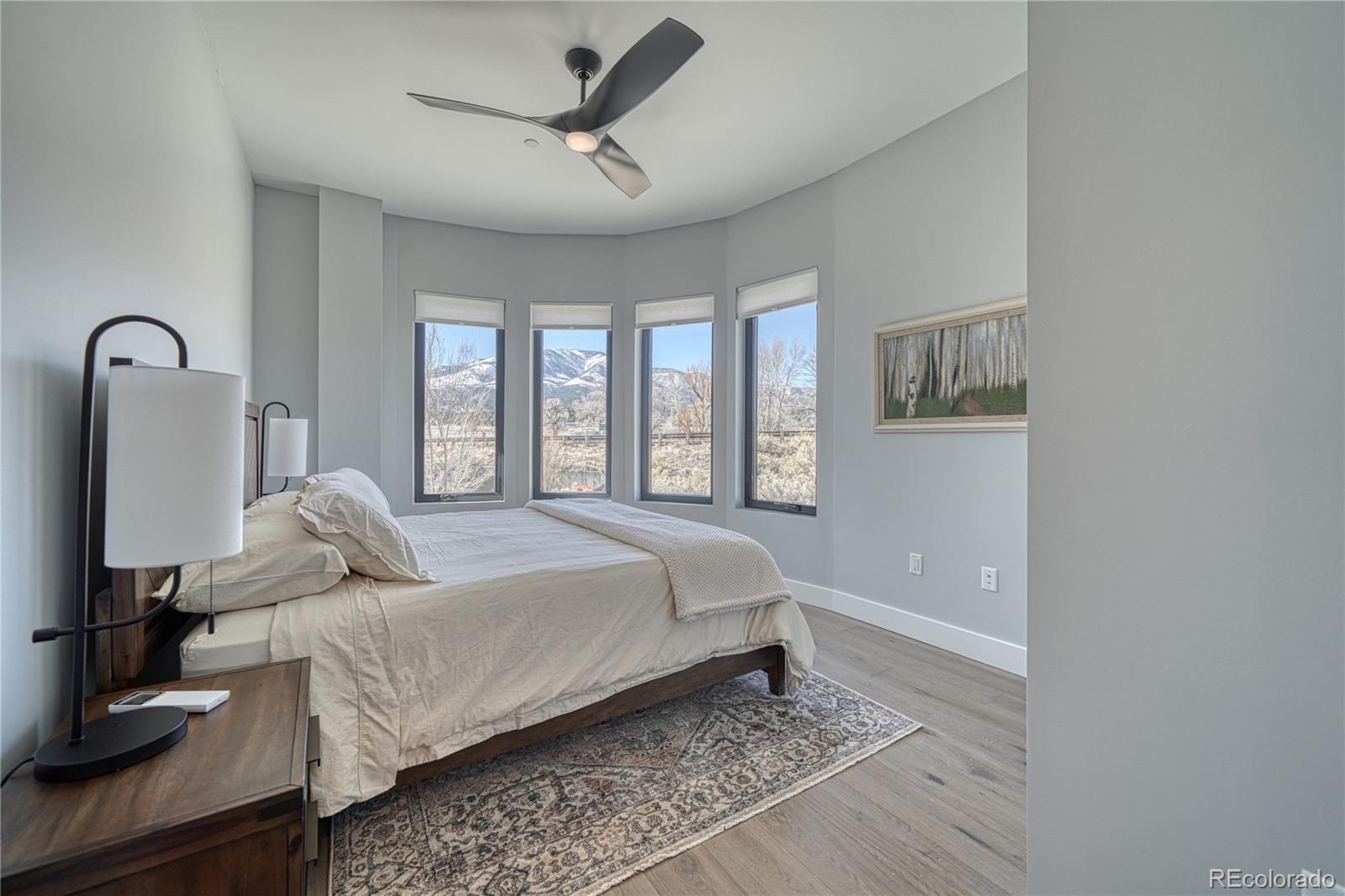 136 Old Stage Road, Unit 1B Salida, CO 81201 - Photo 13 of 24 a bedroom with a bed next to a window with a bookshelf