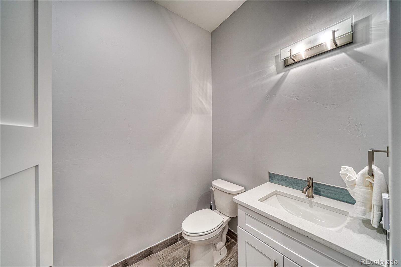 136 Old Stage Road, Unit 1B Salida, CO 81201 - Photo 20 of 24 a white toilet sitting next to a bathroom sink