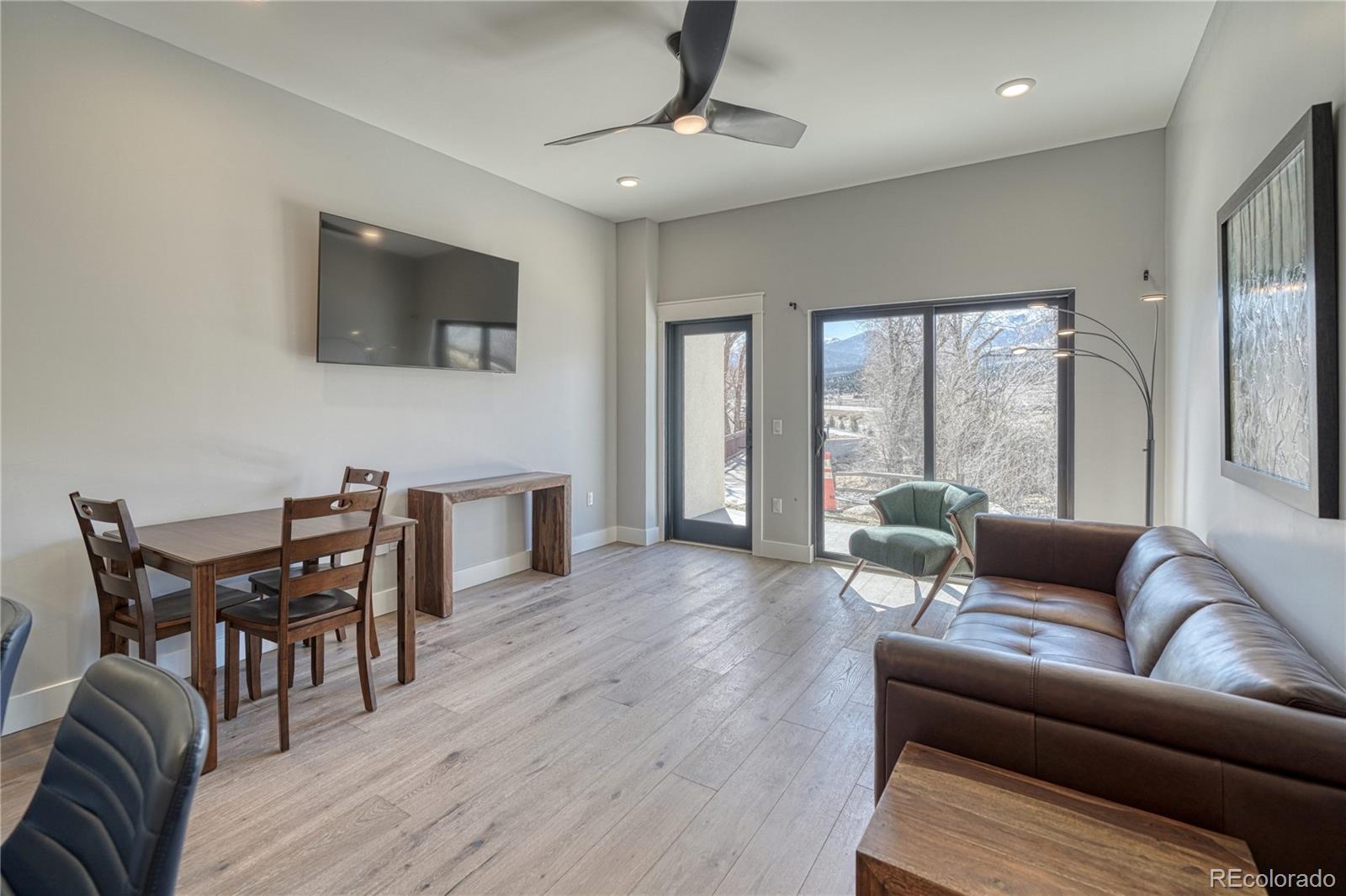 136 Old Stage Road, Unit 1B Salida, CO 81201 - Photo 6 of 24 a living room with furniture a flat screen tv and wooden floor