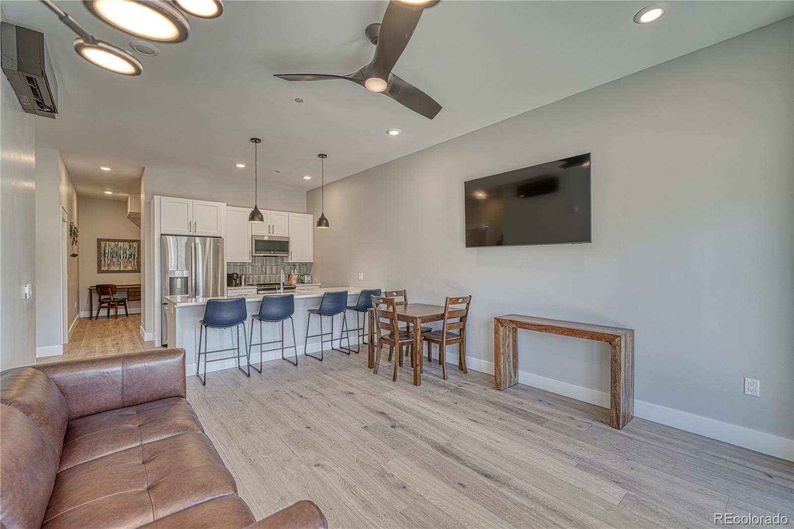 136 Old Stage Road, Unit 1B Salida, CO 81201 - Photo 8 of 24 a living room with furniture a flat screen tv and kitchen view