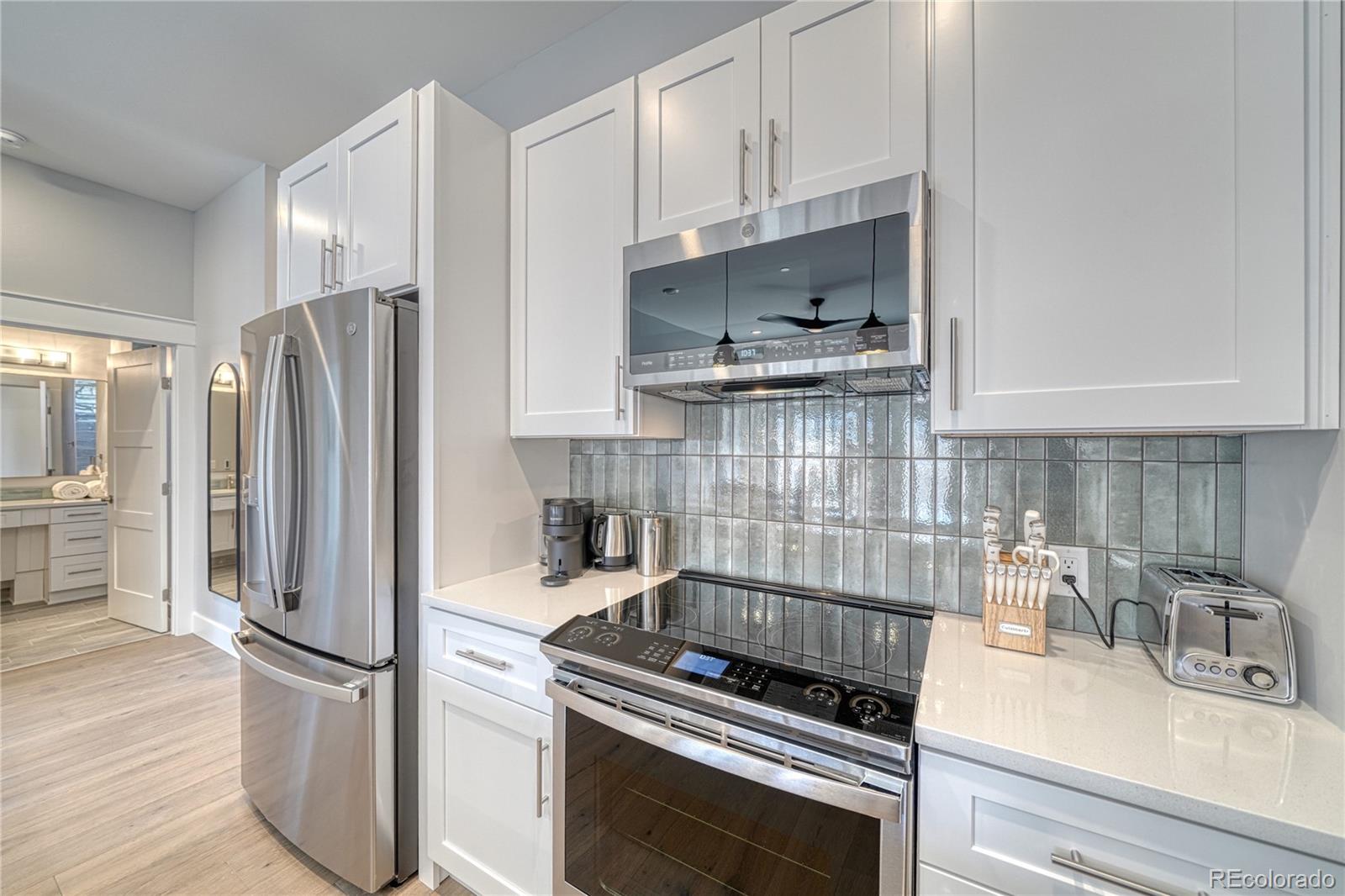 136 Old Stage Road, Unit 1B Salida, CO 81201 - Photo 10 of 24 a kitchen with stainless steel appliances granite countertop a refrigerator sink and stove