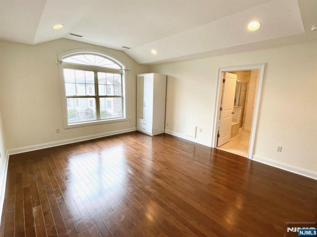 1625 Paterson Plank Road, Unit 18 Secaucus, NJ 07094 - Photo 14 of 23 an empty room with wooden floor and windows