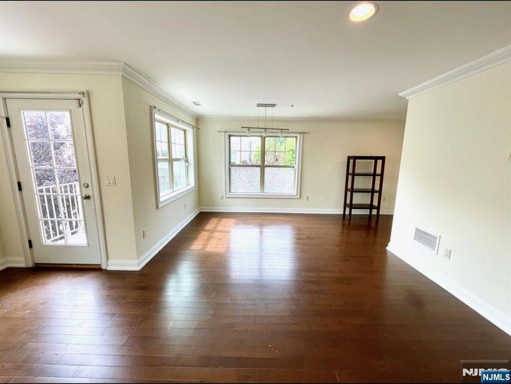 1625 Paterson Plank Road, Unit 18 Secaucus, NJ 07094 - Photo 5 of 23 a view of an empty room with wooden floor and a window