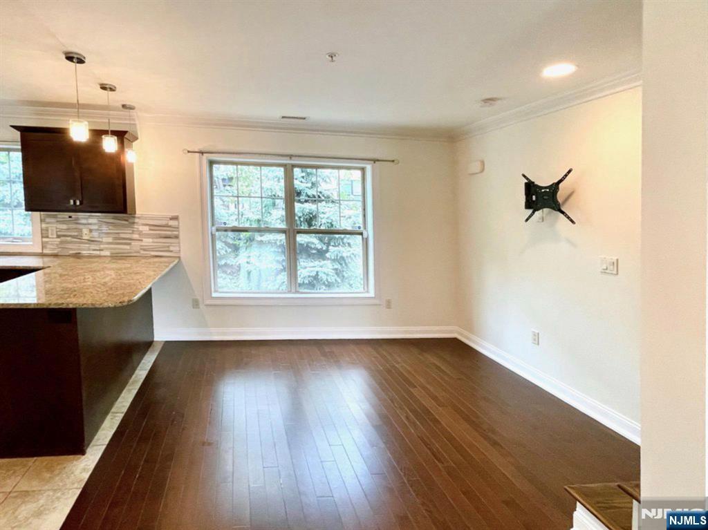 1625 Paterson Plank Road, Unit 18 Secaucus, NJ 07094 - Photo 7 of 23 an empty room with wooden floor and windows