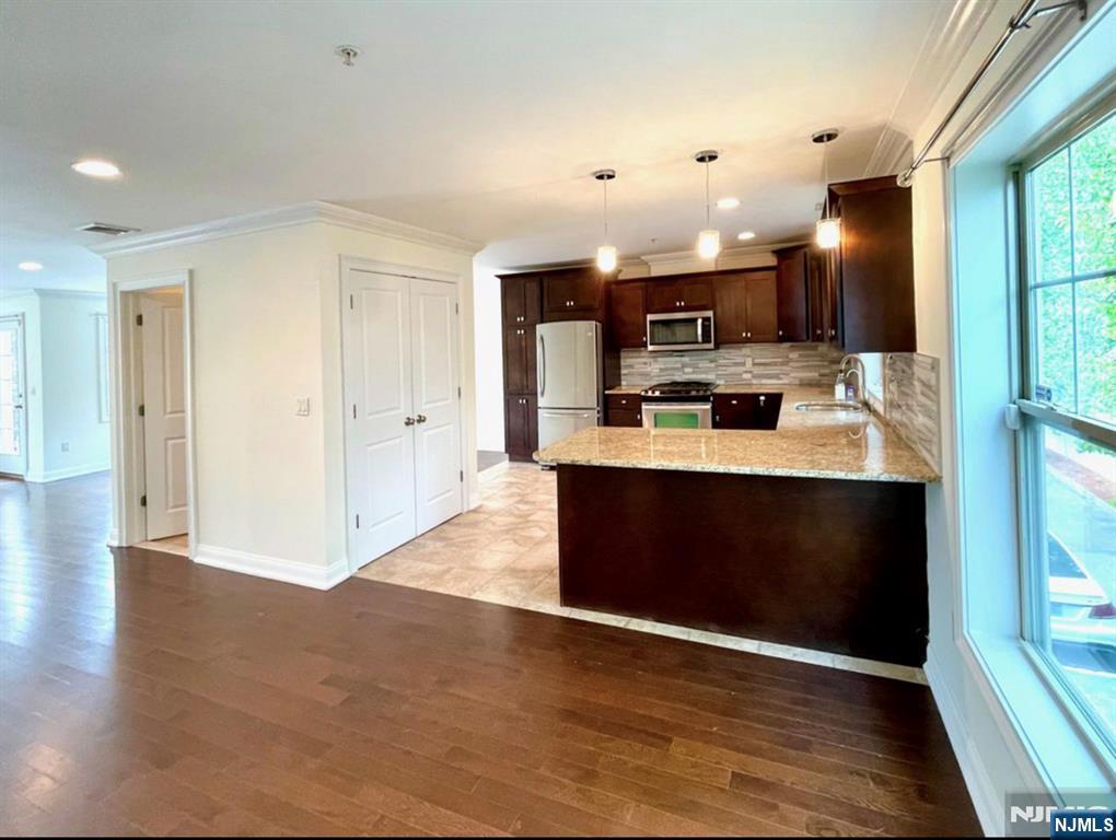 1625 Paterson Plank Road, Unit 18 Secaucus, NJ 07094 - Photo 9 of 23 a view of kitchen with kitchen island stainless steel appliances a sink cabinets and wooden floor