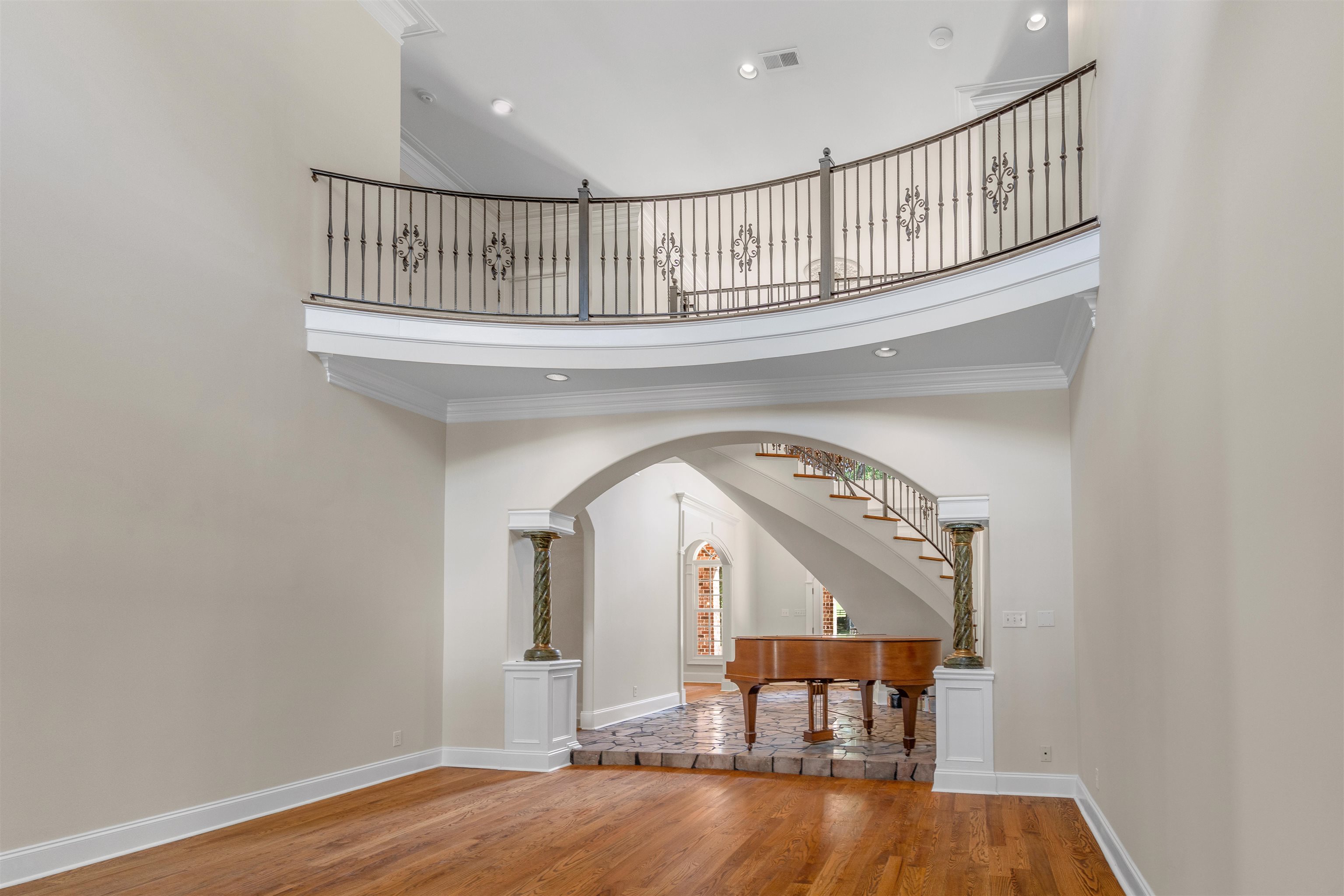 815 Dent Road Eads, TN 38028 - Photo 5 of 40 Entryway featuring a towering ceiling, light wood finished floors, ornamental molding, arched walkways, and recessed lighting