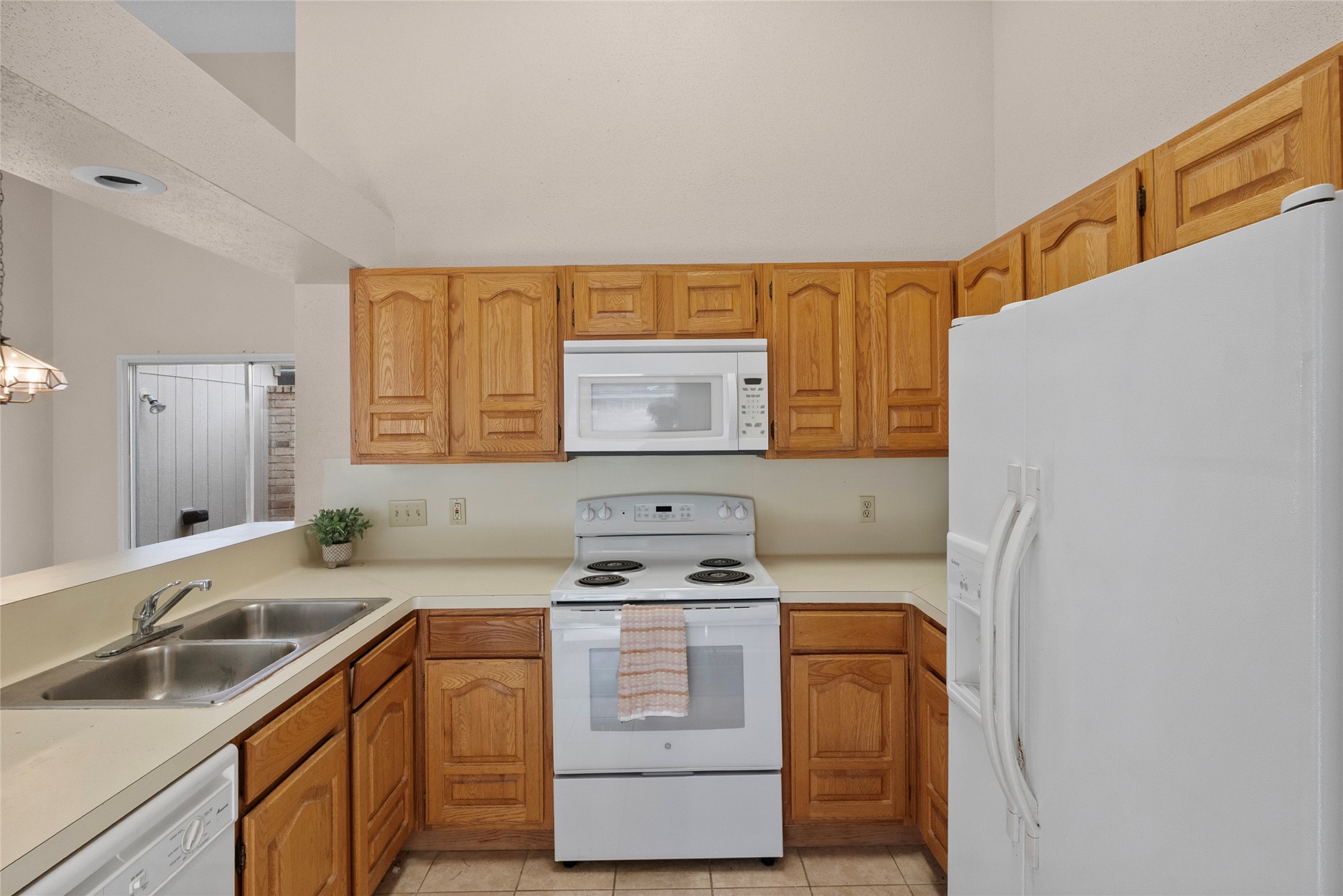 13222 Maplecrest Drive Houston, TX 77041 - Photo 14 of 31 a kitchen with a stove cabinets and a sink