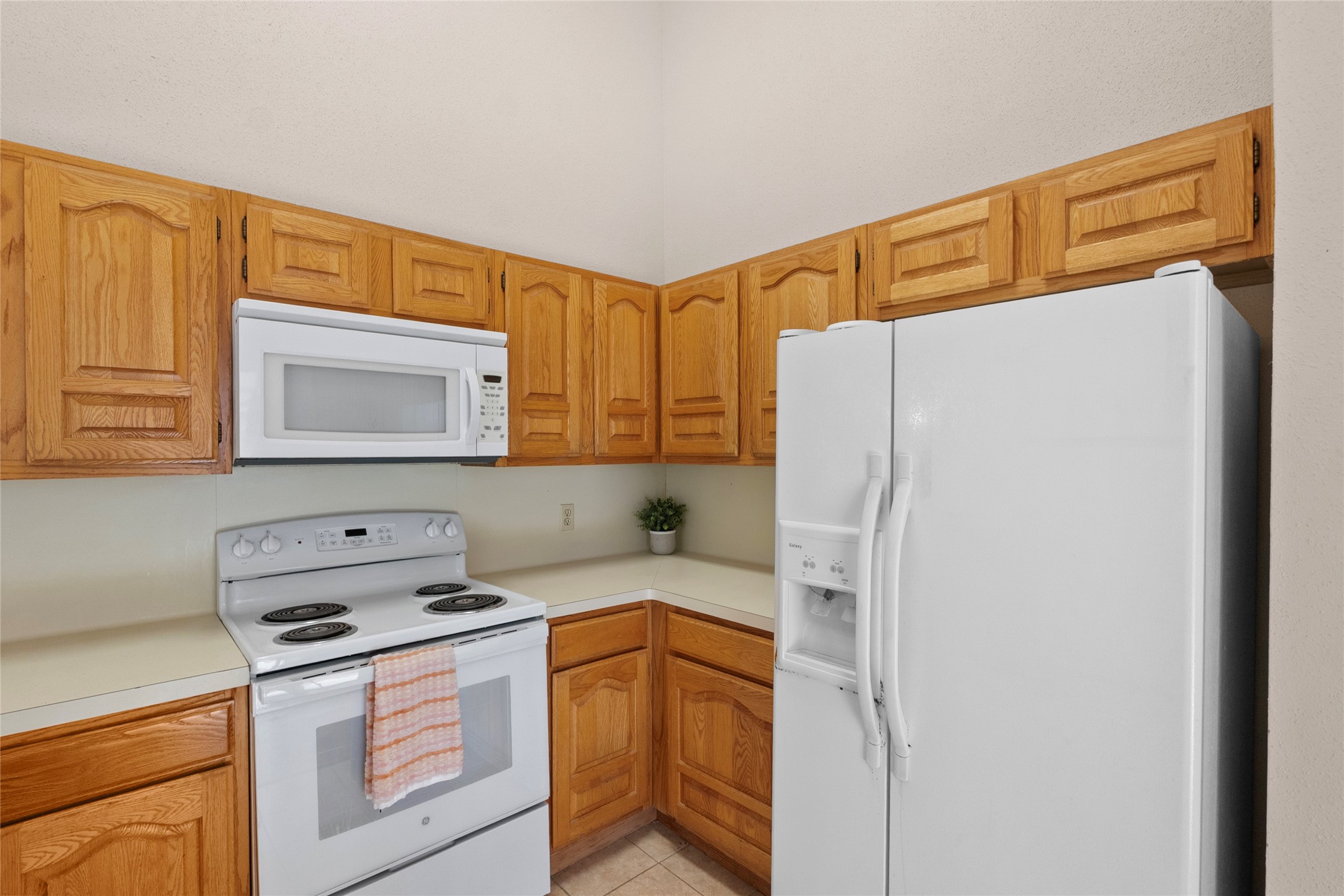 13222 Maplecrest Drive Houston, TX 77041 - Photo 16 of 31 a kitchen with a refrigerator a stove a sink and a cabinets
