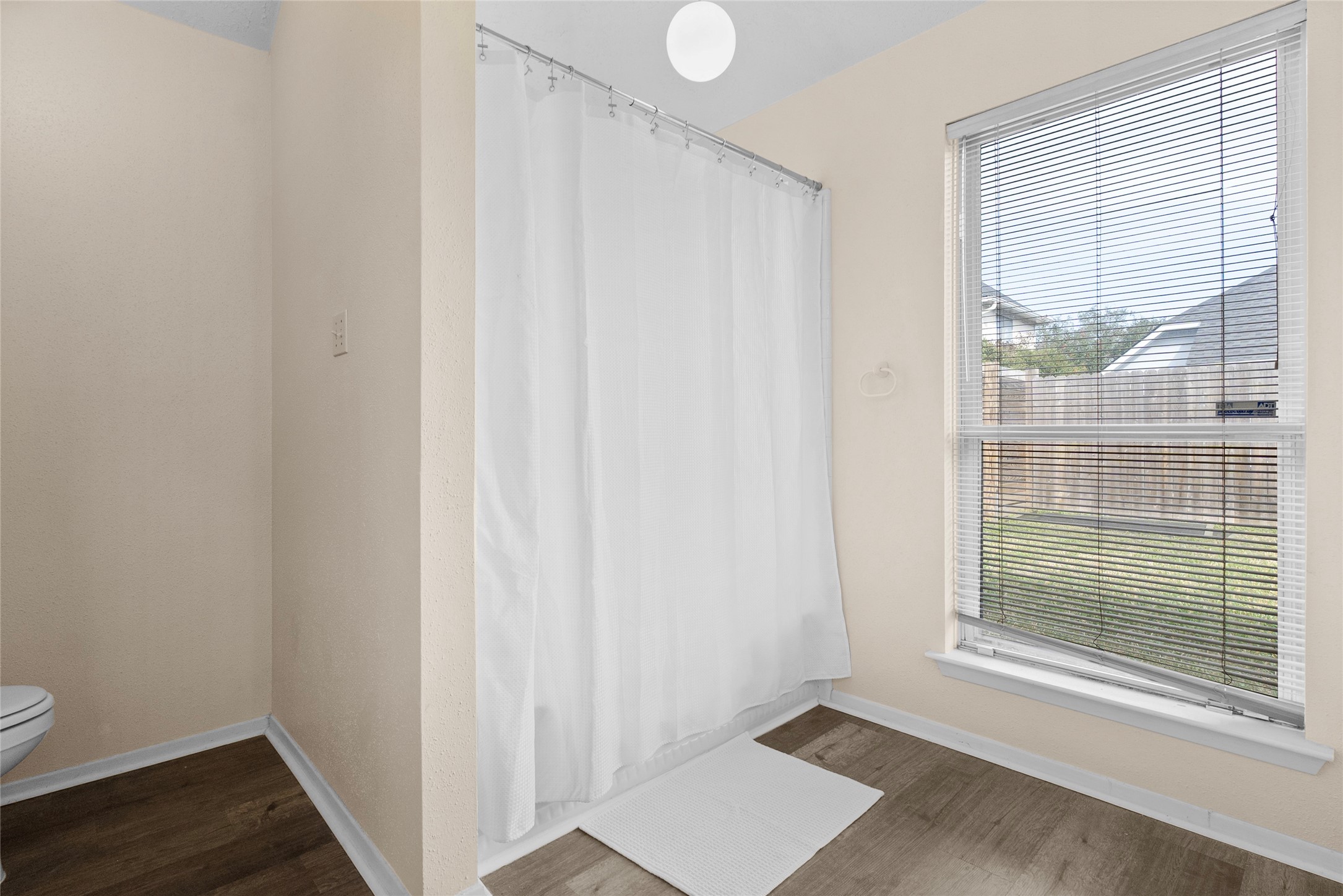 13222 Maplecrest Drive Houston, TX 77041 - Photo 25 of 31 a view of an empty room with wooden floor and a window