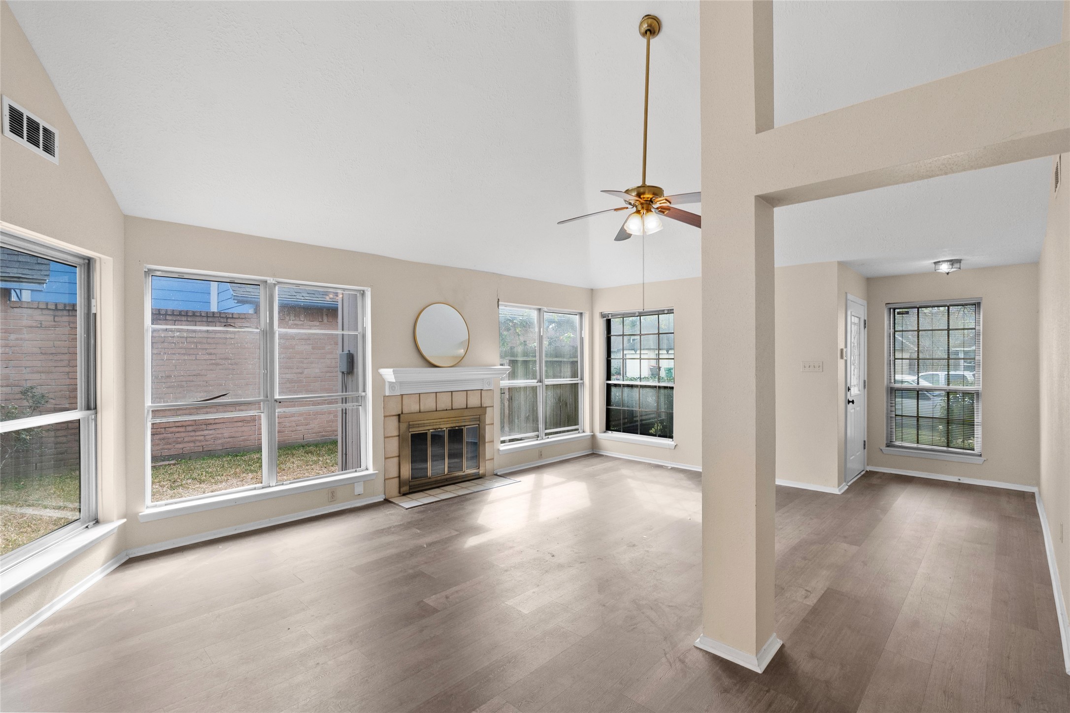 13222 Maplecrest Drive Houston, TX 77041 - Photo 8 of 31 a view of a livingroom with wooden floor a fireplace and window