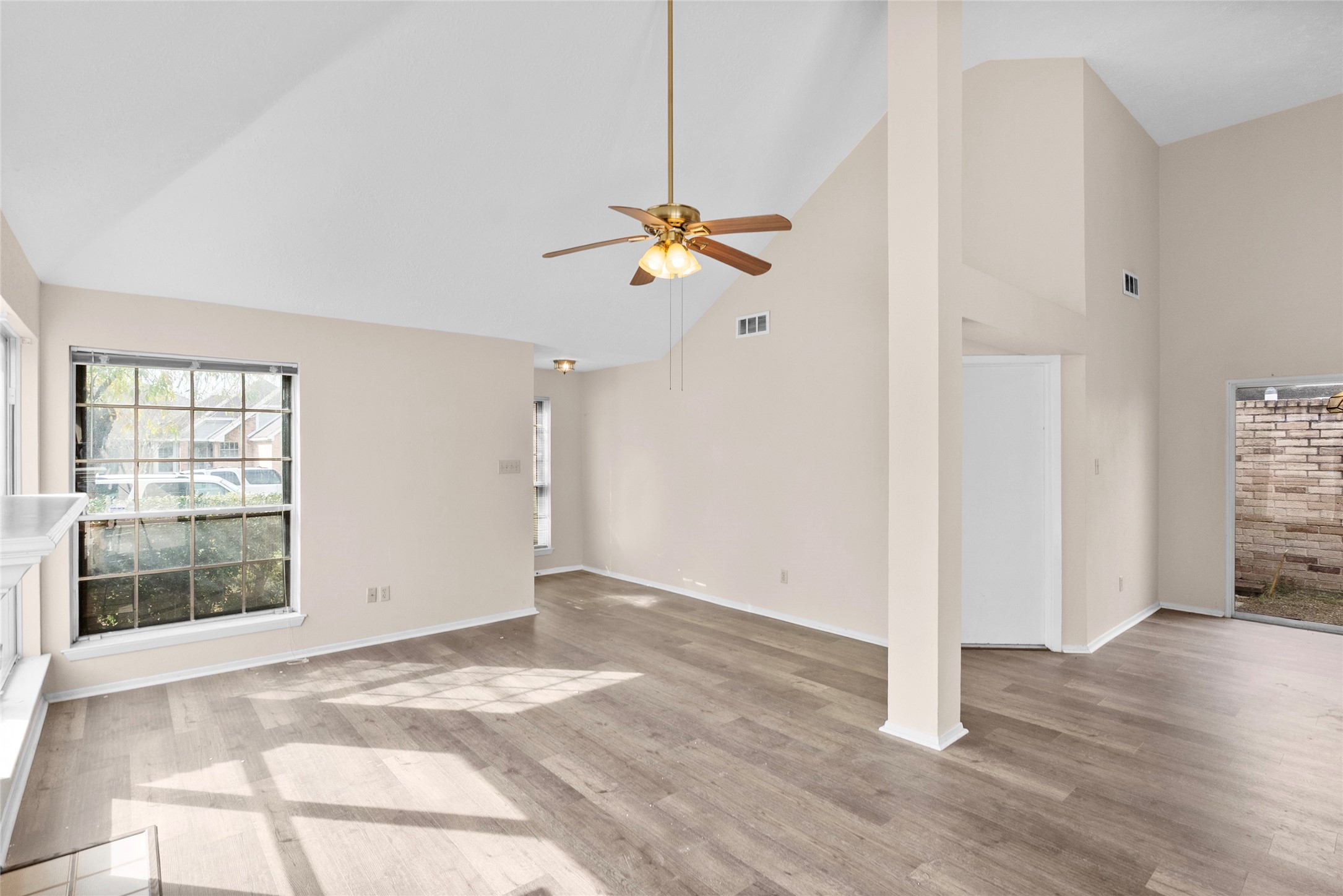 13222 Maplecrest Drive Houston, TX 77041 - Photo 9 of 31 a view of an empty room with a window and wooden floor