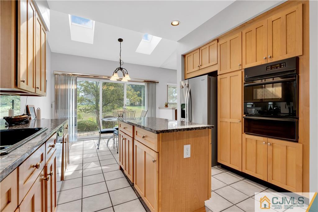 45 Harwood Road Monroe Township, NJ 08831 - Photo 13 of 35 a kitchen with stainless steel appliances granite countertop a stove a sink and a refrigerator