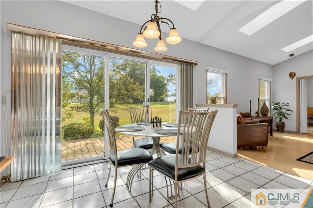 45 Harwood Road Monroe Township, NJ 08831 - Photo 18 of 35 a view of a dining room with furniture wooden floor and a chandelier