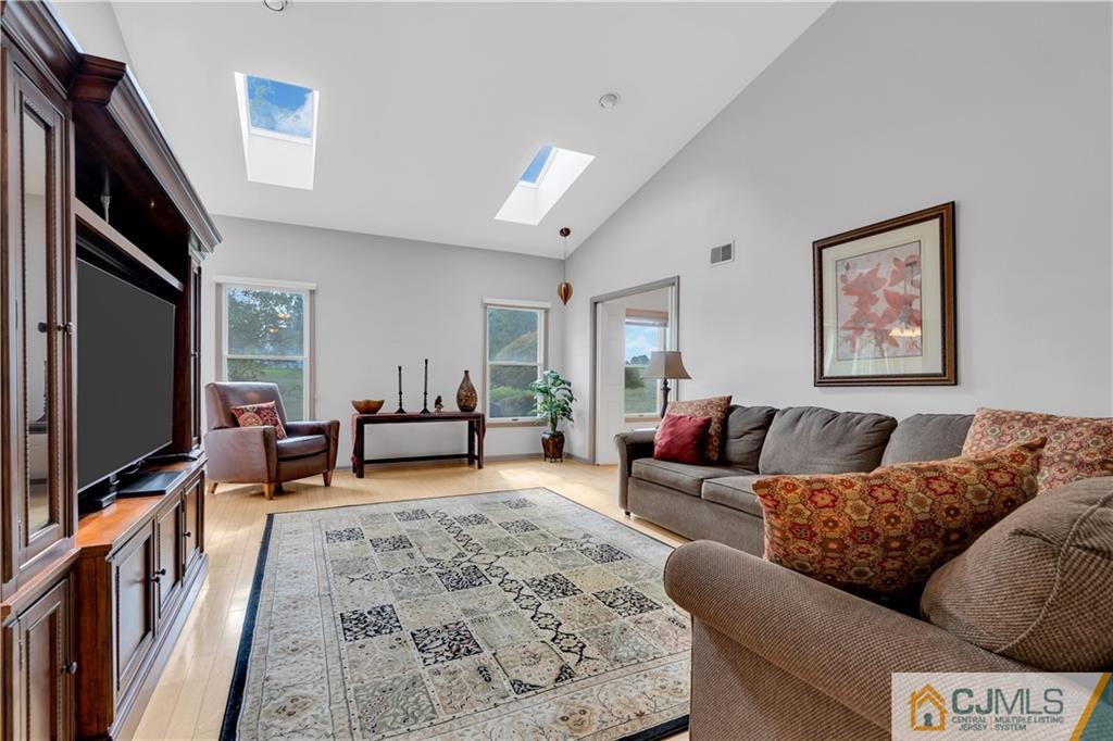 45 Harwood Road Monroe Township, NJ 08831 - Photo 20 of 35 a living room with furniture and a flat screen tv