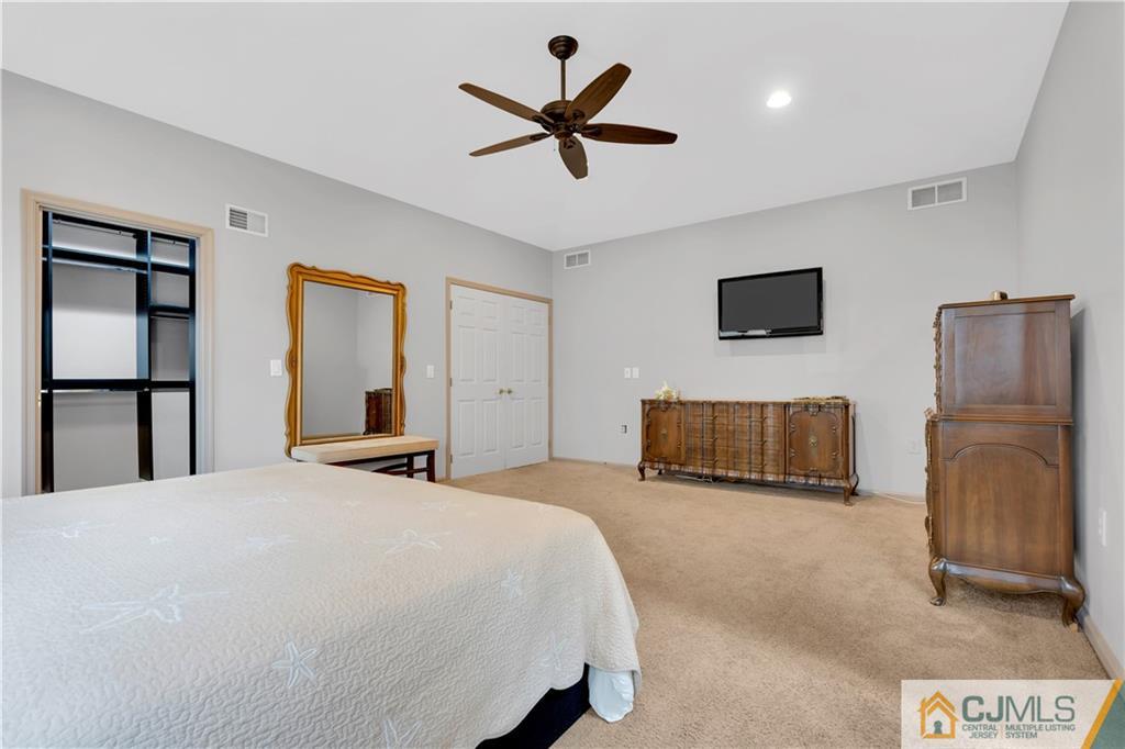 45 Harwood Road Monroe Township, NJ 08831 - Photo 24 of 35 a bedroom with a bed and a flat screen tv