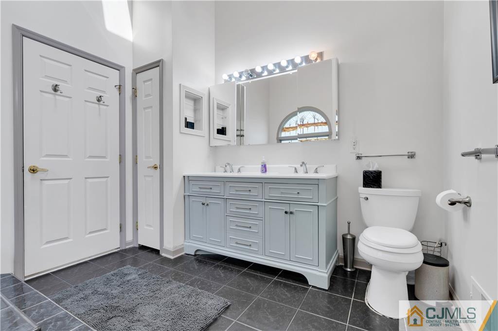 45 Harwood Road Monroe Township, NJ 08831 - Photo 25 of 35 a bathroom with a toilet a sink and a mirror