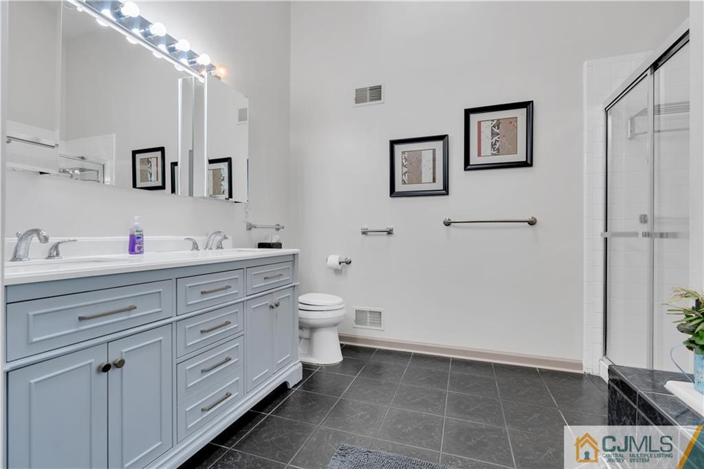 45 Harwood Road Monroe Township, NJ 08831 - Photo 26 of 35 a bathroom with a toilet sink and mirror