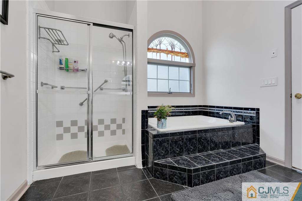 45 Harwood Road Monroe Township, NJ 08831 - Photo 27 of 35 a bathroom with a tub and a shower