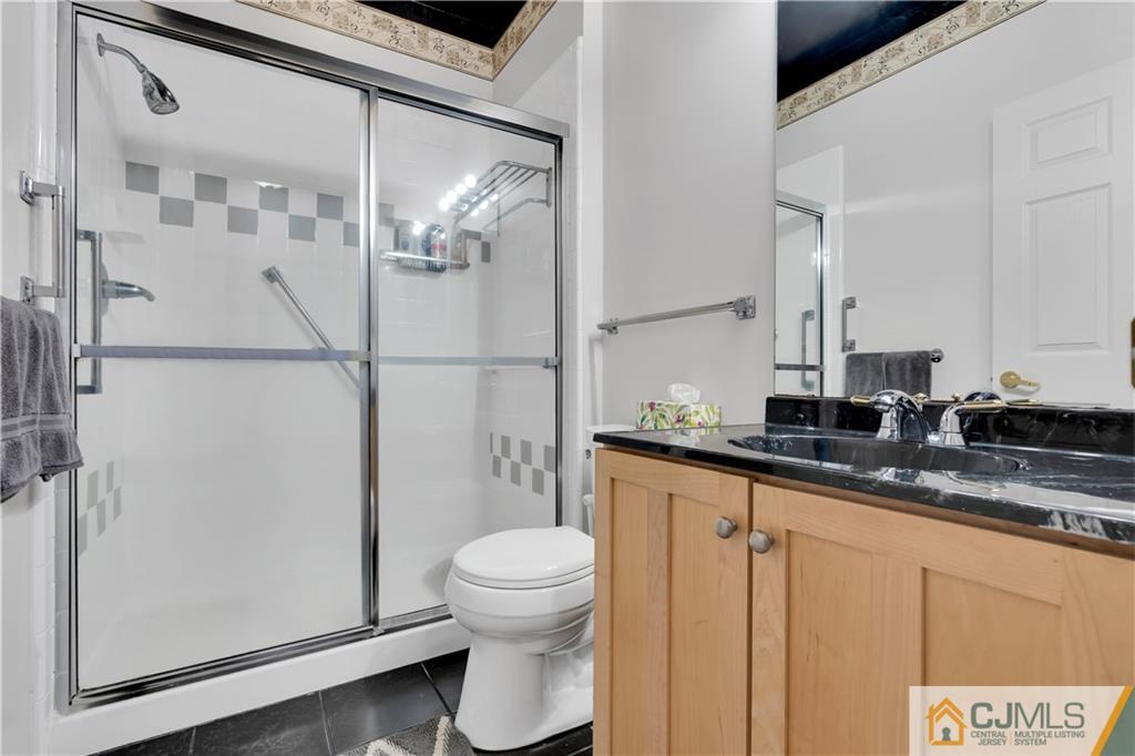 45 Harwood Road Monroe Township, NJ 08831 - Photo 30 of 35 a bathroom with a granite countertop sink mirror vanity and toilet