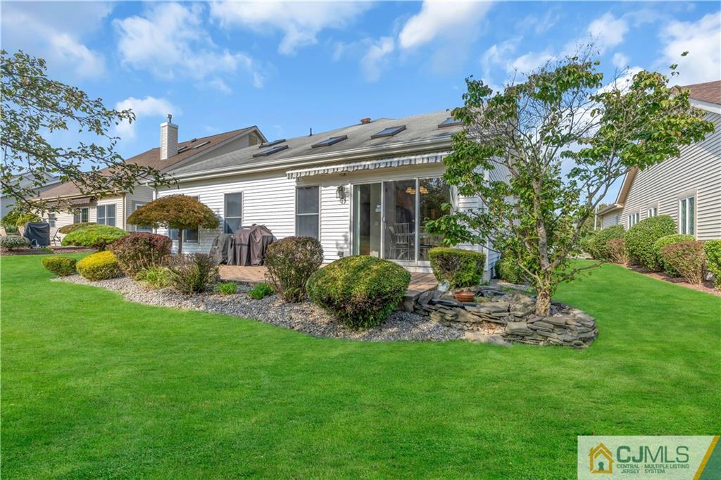 45 Harwood Road Monroe Township, NJ 08831 - Photo 34 of 35 a view of a patio with table and chairs potted plants and large tree