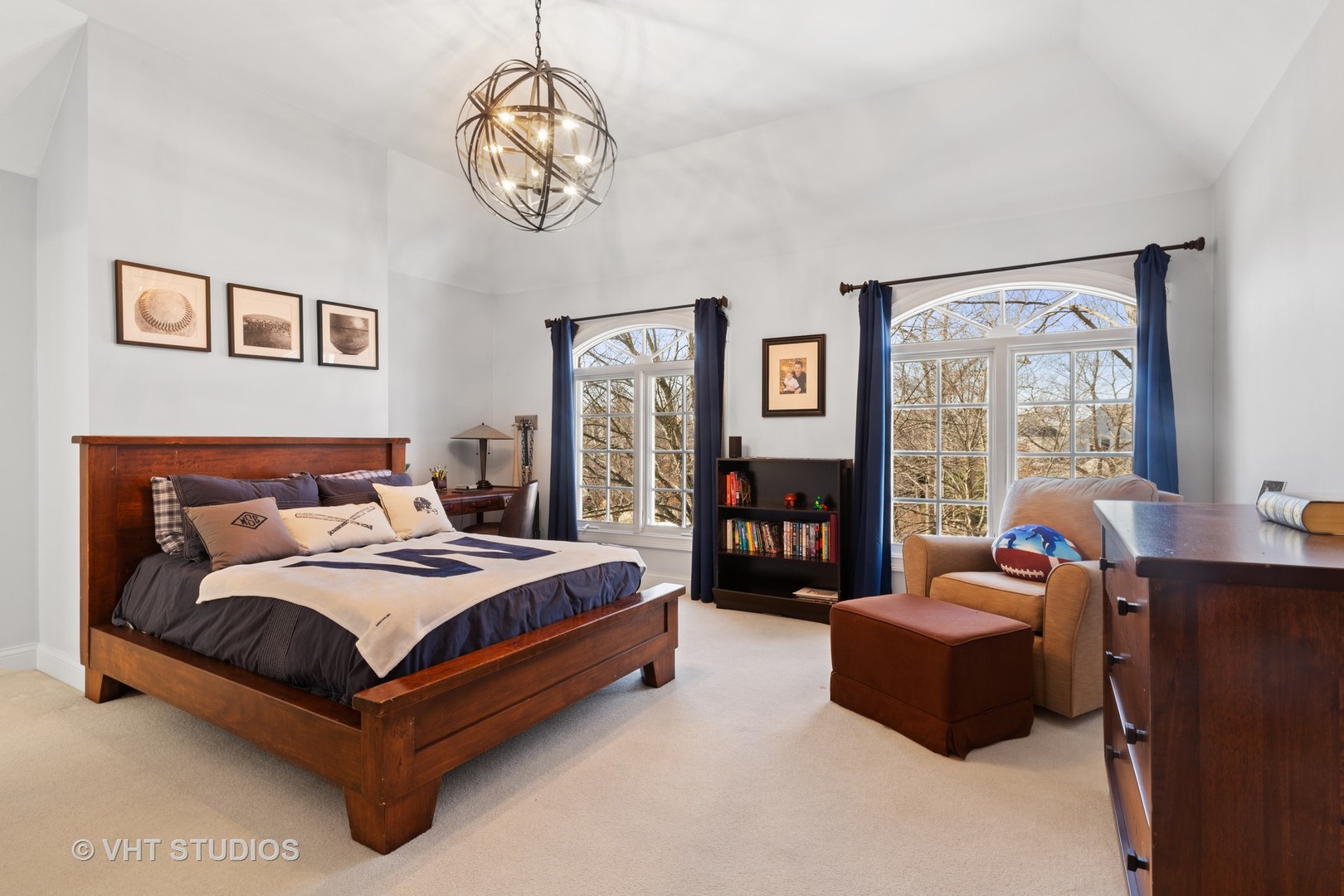 795 Grove Street Glencoe, IL 60022 - Photo 22 of 38 a spacious bedroom with a bed and a chandelier